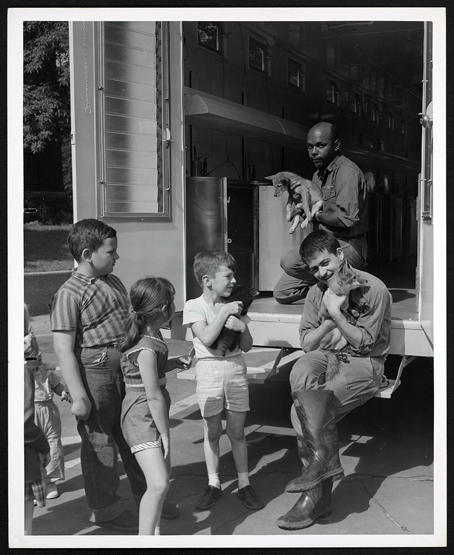 Senior keeper Roy Smith holding pup on traveling zoo
